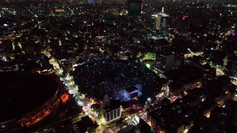 Aerial-view-around-a-rock-band-playing-at-a-stadium-in-Mexico-city---circling,-drone-shot