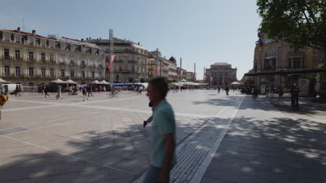 Place-De-La-Comedie,-Montpellier,-France---People-Walking-Around-Central-Square-On-Beautiful-Sunny-Day