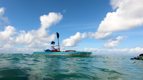 Lifeguard-on-duty-watching-kids-playing-in-water-near-a-beach-|-Lifeguard-on-watch-using-kayak-on-beach-taking-care-of-tourists-|-Lifesaver,-lifeguard-at-sea,-rescue,-Baywatch,-tourism