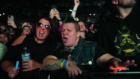 Joyful-Excited-Spectators,-Young-Women-Ladies-Cheering-Singing-Dancing-During-Music-Concert-Show,-Crowd-Around-and-Arena-Stands-in-Background,-Youth-and-Entertainment