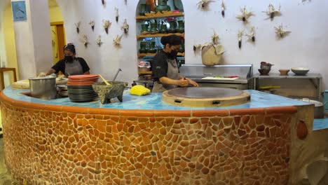 couple-of-cooks-making-tortillas-on-a-griddle-in-oaxaca