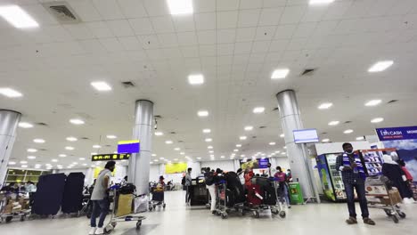 Low-angle-shot-of-inside-of-a-queue-in-a-departure-hall-area-in-Hydrabad-Airport,-India-for-international-and-domestic-flight-travel-at-daytime