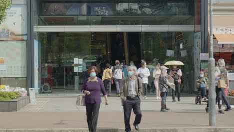 Chinese-walking-outdoor-with-protective-mask-in-crowded-metropolitan-area