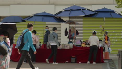 pedestrian-walking-near-local-stand-seller-vendor