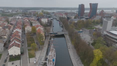 The-Dane-river-flowing-in-the-center-of-the-city,-where-the-old-town-is-on-the-left-bank,-the-park-has-been-renovated-on-the-right-bank,-and-the-Meridian-sailing-ship-stands-in-the-river