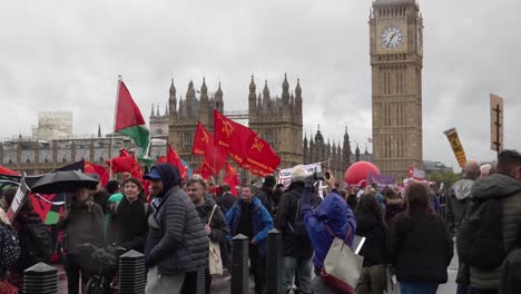 A-group-from-the-young-communist-league-gather-on-Westminster-Bridge-in-central-London,-UK