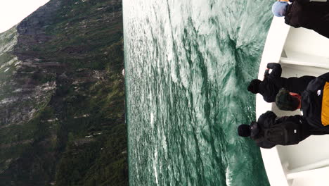 Vertical-clip-of-bow-of-boat-with-people-in-doubtful-sounds-fjords,-New-Zealand-Southland,-south-island,-New-Zealand,-Fiordland-national-park