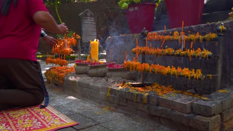 People-offering-candles-and-praying-at-Buddhist-Temple-in-Thailand