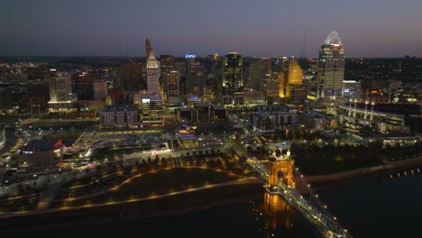 Cincinnati-city-and-the-Roebling-bridge,-fall-evening-in-Ohio,-USA---Aerial-view