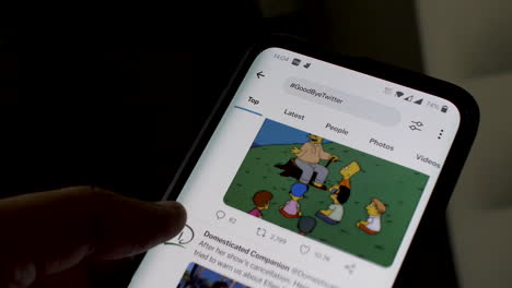 Finger-Scrolling-Through-Goodbye-Twitter-Hashtag-On-Smartphone