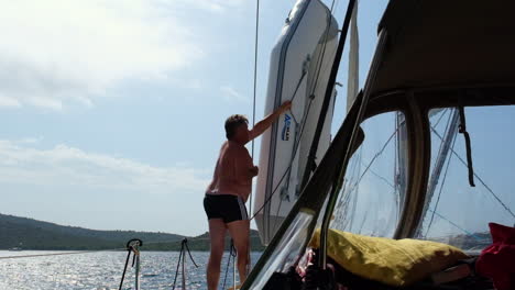 2-men-pulling-one-dinghy-up-to-the-sailboat