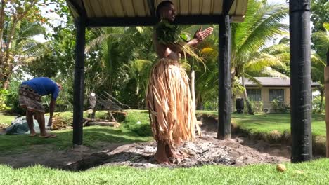 Fiji-fire-walker-hot-rocks-Local-dancer-steps-on-a-hot-stone-and-ashes