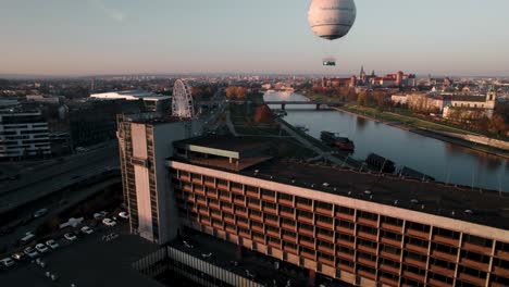 Aerial-View-of-Man-Standing-on-the-Rooftop-of-High-Old-Hotel-at-sunset