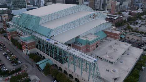 Aerial-view-around-the-Minute-maid-park,-cloudy-sunrise-in-Houston,-USA---circling,-drone-shot