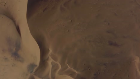 Drone-shot-of-the-Namib-desert-in-Namibia---drone-is-flying-over-the-lonely-desert-and-dry-dunes-in-top-down-modus