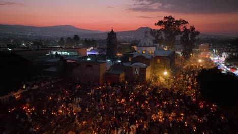 Aerial-view-low-over-the-illuminated-Mixquic-cementary,-Dia-de-los-Muertos-in-Mexico