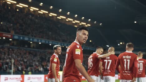 Professional-Football-Players-Celebrate-after-Scoring-Goal-Pitch-View