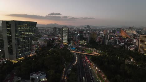 Aerial-view-approaching-the-Petroleos-Fountain,-sunny-evening-in-Mexico-city