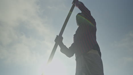 Boatman-rowing-with-oars-in-the-river-with-maximum-effort