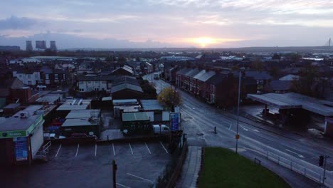 Early-morning-sunrise-aerial-view-over-rainy-British-industrial-town-neighbourhood-roads