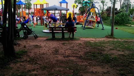 Public-park-with-kids-playing-on-the-playground-in-Asuncion,-Paraguay