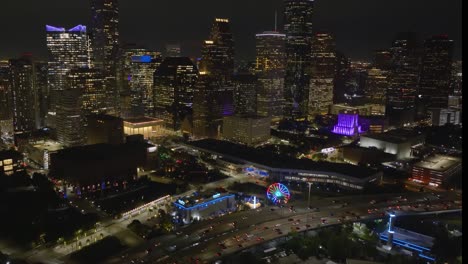 Vista-Aérea-Del-Acuario-Iluminado-Del-Centro-Y-El-Carrusel-Acuático,-Tarde-En-Houston,-Estados-Unidos