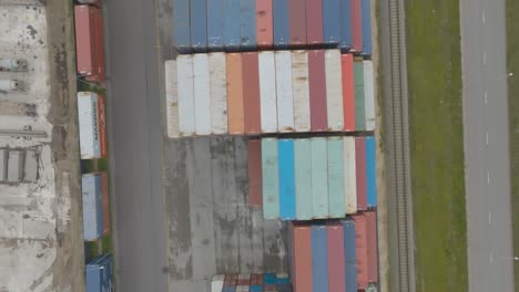 Top-view-of-many-empty-metal-sea-containers-lined-up-in-a-port-terminal