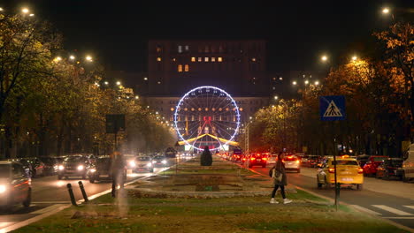 Bucharest-Christmas-Market,-Ferris-wheel-and-illumination-with-traffic,-Bucharest-,Romania