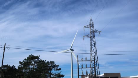 Spinning-wind-turbine-with-power-lines-and-cables-in-front