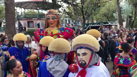 slow-motion-shot-of-dancers-wearing-various-traditional-costumes-in-san-cristobal-de-las-casas-mexico-during-a-wedding-on-a-public-road