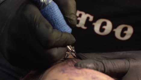 Person-his-arm-being-tattooed-close-up