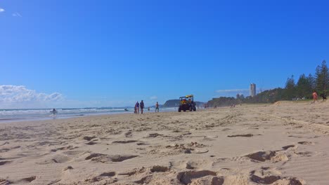 Lifesavers-driving-a-buggy-up-the-beach-on-a-typical-summers-day-at-the-beach