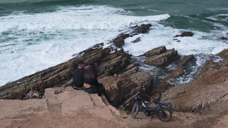 Young-Moroccan-couple-sitting-by-the-ocean-in-Casablanca-Morocco