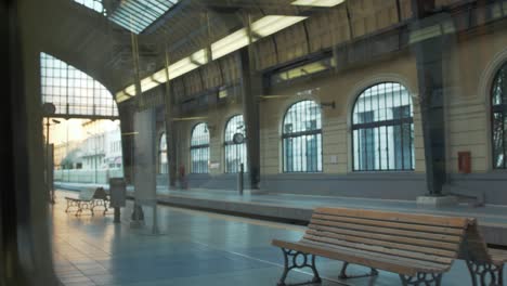 Train-window-POV-shot-pulling-out-of-Piraeus-station