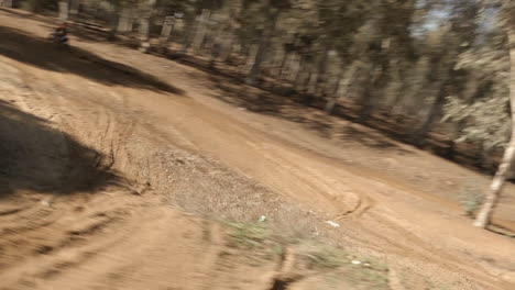 Fpv-Drohne-Folgt-Motocross-Dirt-Bike-Rennfahrer-Auf-Sandigem-Feldweg