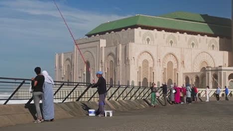 Morocan-in-front-of-Hassan-II-mosque-in-Casablanca-Morocco