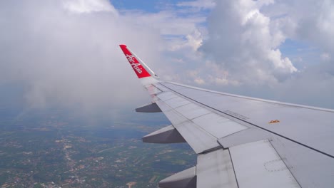 Looking-out-from-airplane-window-flying-over-wide-open-landscape