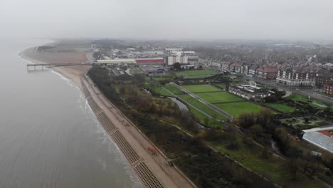 Drone-footage-of-Foggy-morning-along-the-Skegness-coastline,-Lincolnshire,-UK