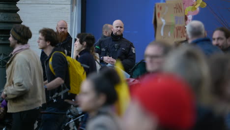 Berlin-police-force-watching-economic-inflation-protest-crowd-marching-slow-motion-demonstration