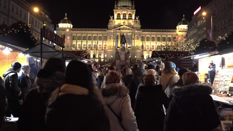 People-walking-through-Christmas-market-below-Prague-National-Museum