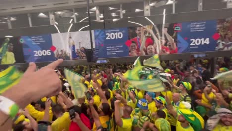 Crowded-station-with-Brazilian-fans-celebrating-on-underground-subway,-Doha