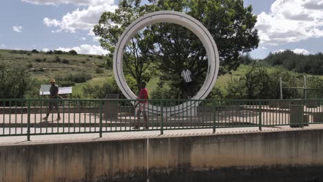 African-tourists-enjoy-giant-pipeline-section-at-Ash-River-Outfall,-ZA