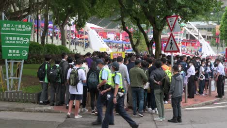 Spectators-queue-in-line-to-enter-the-stadium-holding-the-Hong-Kong-Seven-rugby-tournament,-one-the-city's-highest-profile-sport-event,-after-being-cancelled-due-to-covid-19-government-restrictions