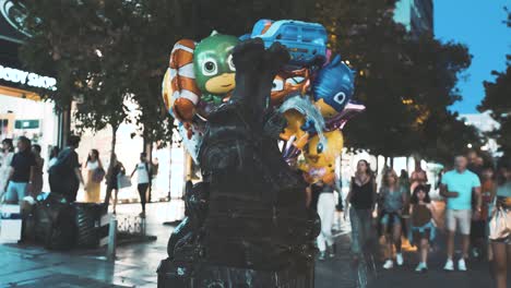 Vendor-selling-kids-helium-balloons-on-Ermou-Street-Mid-Wide-Shot