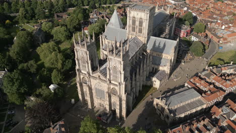 Pullback-Aerial-Drone-Shot-of-Old-Iconic-Roman-British-City-Centre-York-with-Old-Buildings-and-Trees-Flying-Towards-Famous-York-Minster-Cathedral-North-Yorkshire-UK