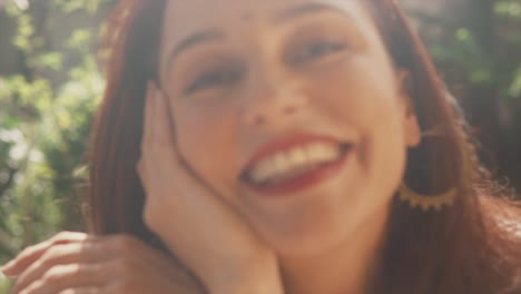 Portrait-of-a-Indian-woman-with-a-beautiful-smile,-leaning-her-face-on-her-hand,-on-a-sunny-day-in-Fontainhas,-India