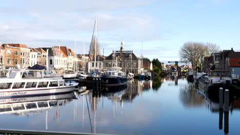 Panning-shot-of-beautiful-canals-with-parking-boats-at-harbor-in-Leiden-City,Netherlands