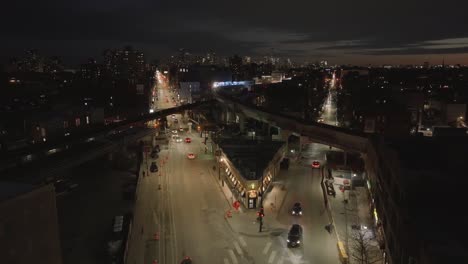 Aerial-view-of-the-illuminated-CTA-holiday-train-on-a-elevated-rail,-night-in-Chicago,-USA