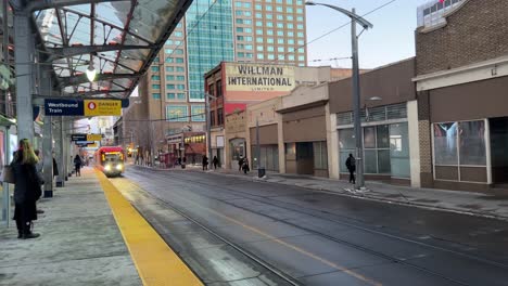 Calgary,-Alberta---December-14,-2022:-View-of-a-C-Train-pulling-up-at-a-commuter-train-platform-in-the-centre-of-Calgary,-Alberta-on-a-cold-winter-evening