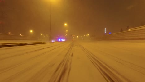 POV-shot-of-emergency-services-attending-a-highway-crash-after-a-heavy-snowfall